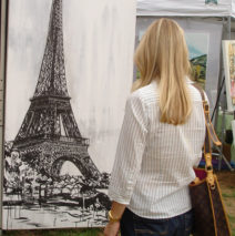 art patron looks at “Eiffel Tower” by Brooke Harker