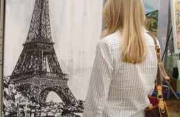 art patron looks at “Eiffel Tower” by Brooke Harker