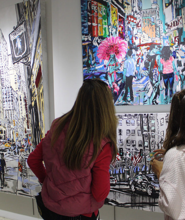 visitors viewing original paintings by Brooke Harker