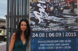 artist Brooke Harker with Italian banner