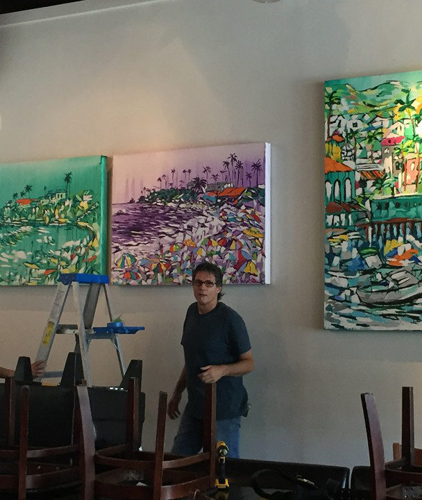 installing paintings at Upper West in Santa Monica