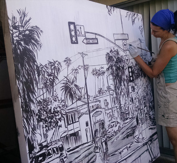 artist Brooke Harker paints the framework of “Boulevard Smile”