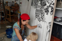 Brooke Harker paints with a toddler assistant