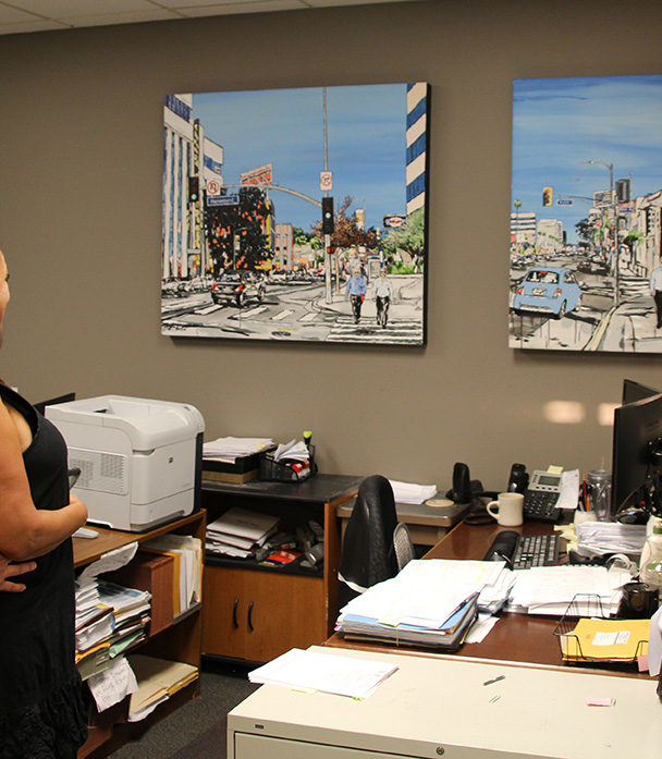 art collectors with paintings in their office by Brooke Harker