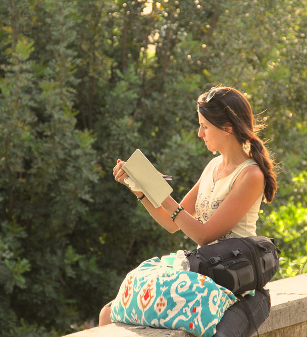 artist Brooke Harker sketching in the sunlight of Rome