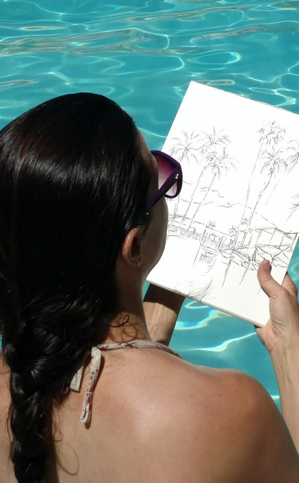 artist Brooke Harker sketching in a pool in Palm Springs