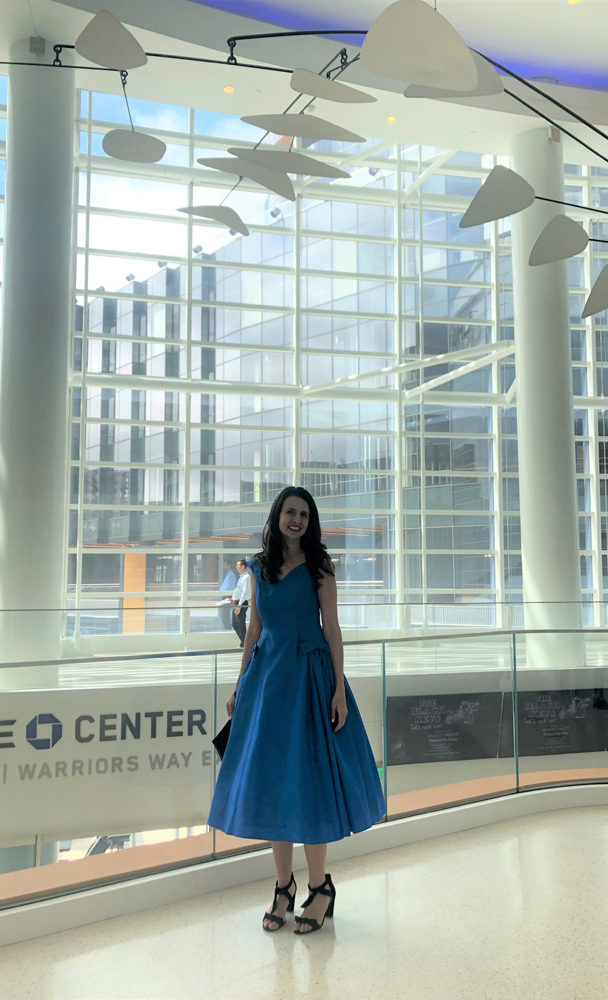 artist Brooke Harker next to the Alexander Calder mobile in the Chase Center