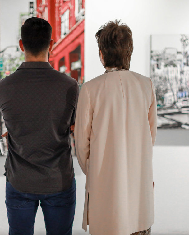 patrons at Castelli Artspace looking at artworks by Harker