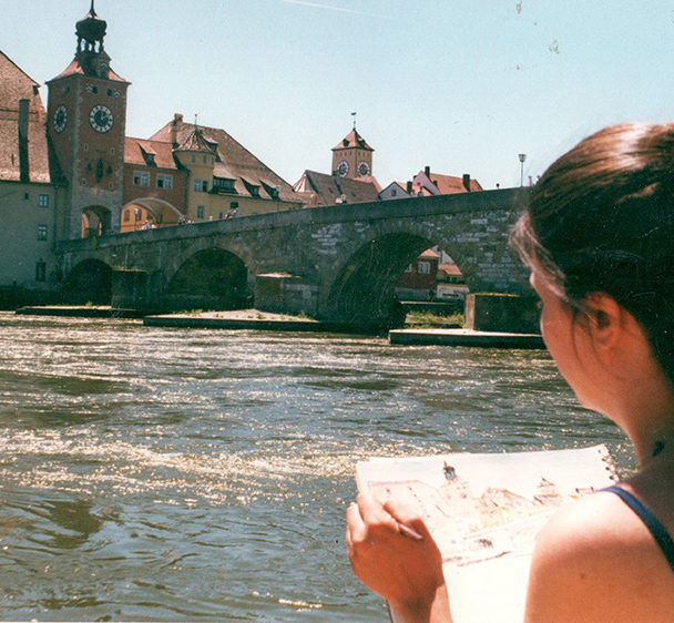 Brooke Harker sketching along the river in Regensburg, Germany