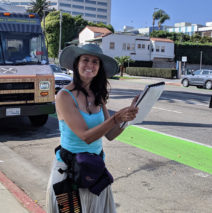 artist Brooke Harker with a belt of rainbow pencils