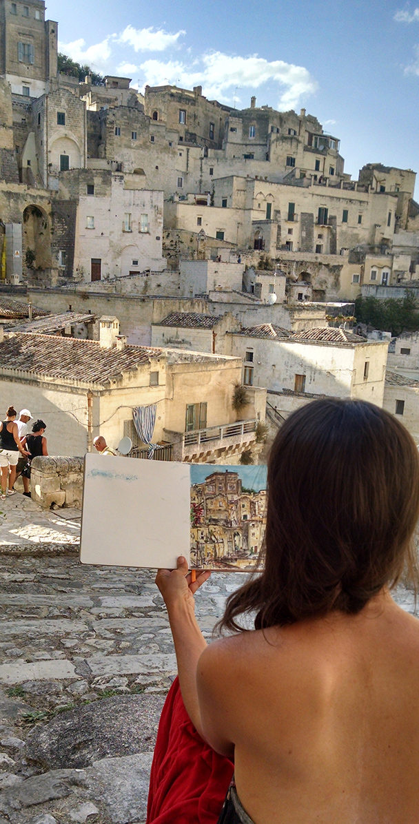 Brooke Harker looking at the first sketch that will inspire “Remembering Matera”