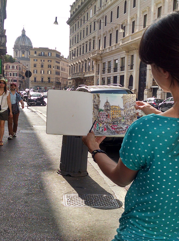 Brooke Harker painting the watercolor in Rome that inspired “All Roads Lead”